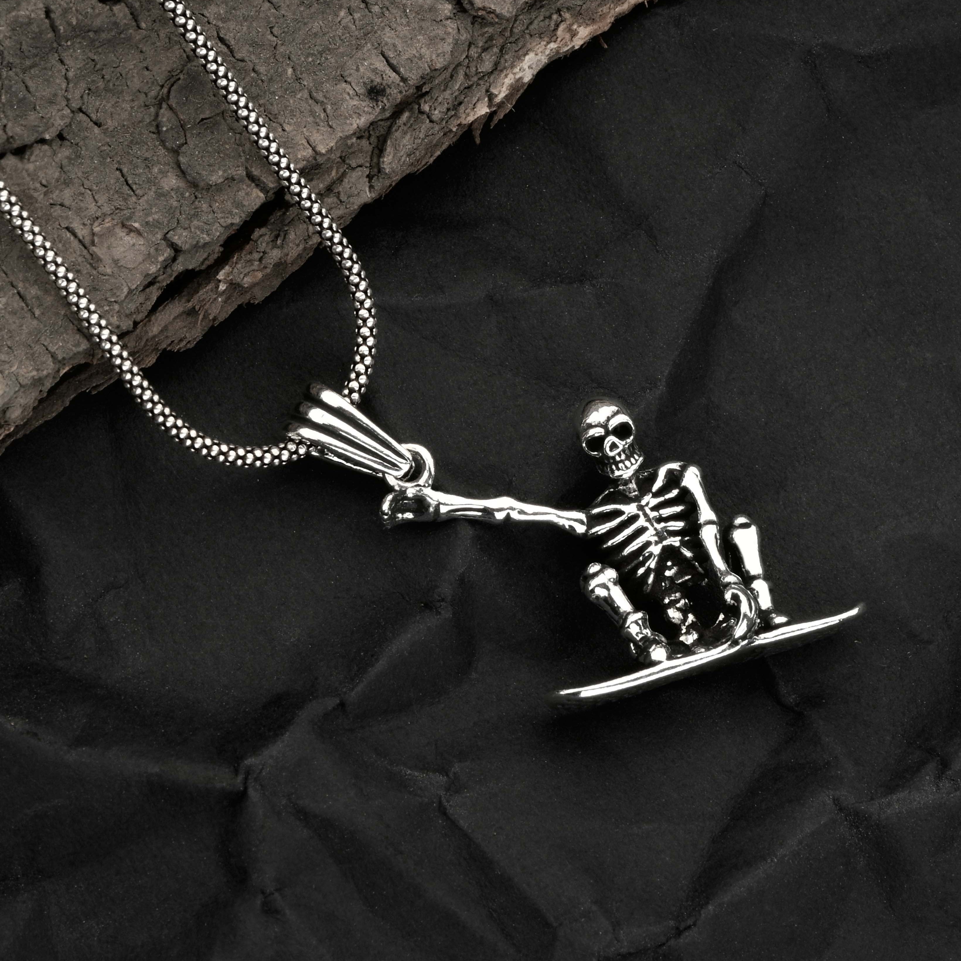 Skeleton pendant on a chain against a dark textured background