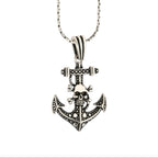 Silver anchor pendant necklace on a white background