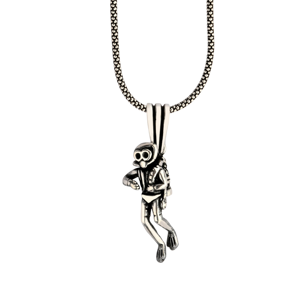 Silver monkey pendant on a chain against a white background