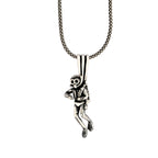 Silver monkey pendant on a chain against a white background