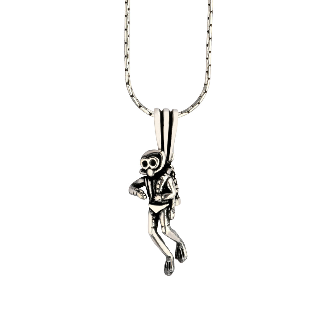 Silver monkey pendant on a chain against a white background