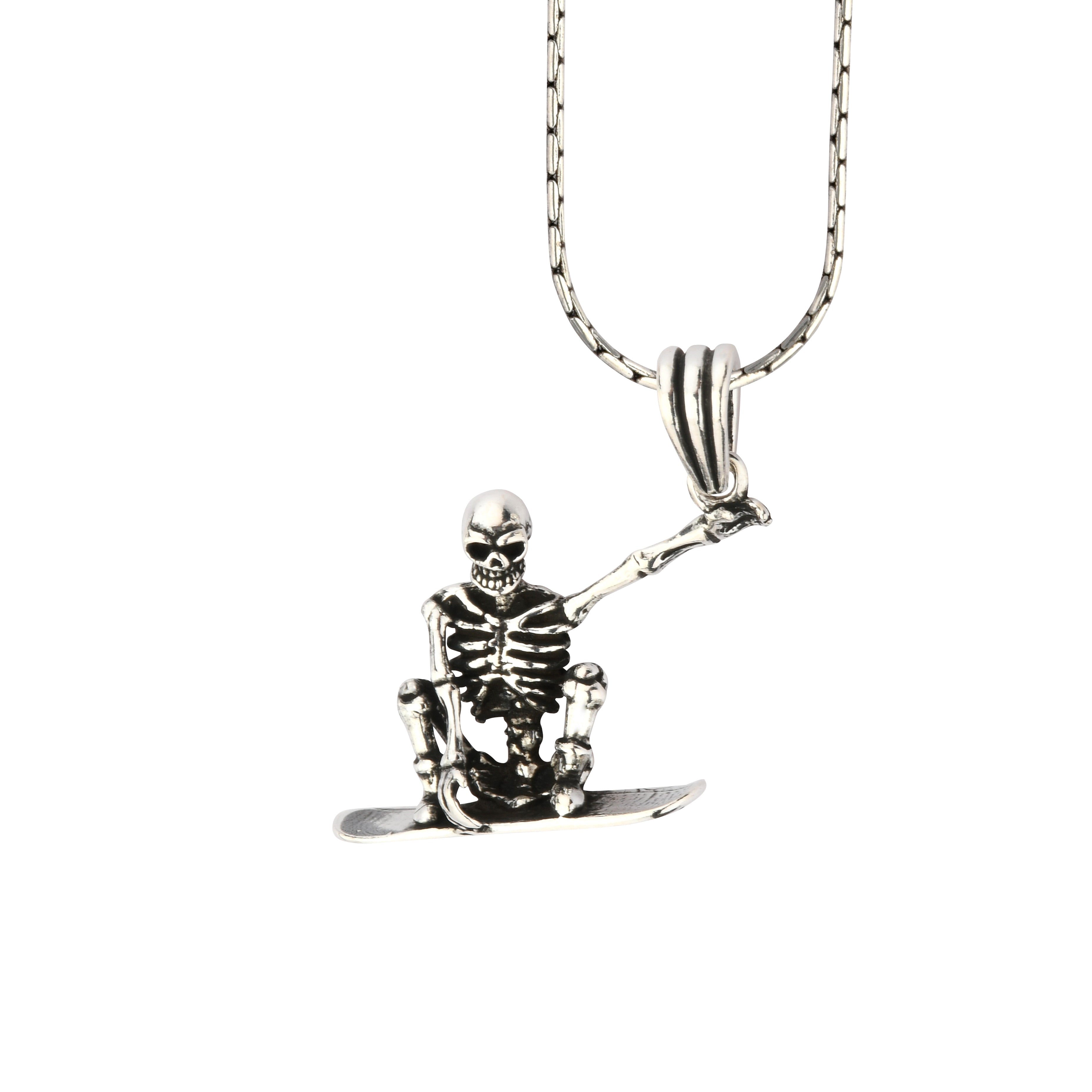 Skeleton pendant on a chain against a white background