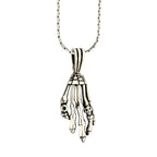 Silver skeleton hand pendant on a chain against a white background